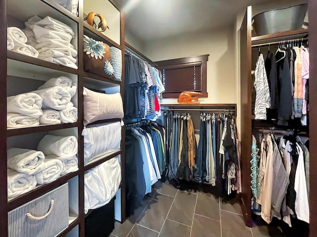 walk in closet with tile patterned floors