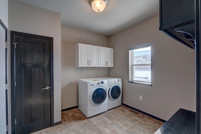 laundry area with cabinet space, independent washer and dryer, and baseboards