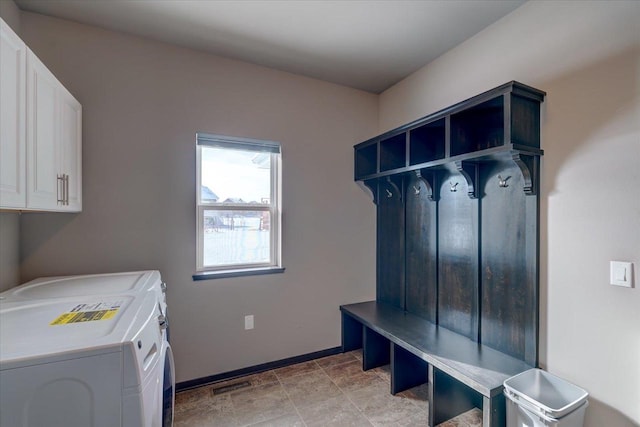 mudroom with washer and clothes dryer, visible vents, and baseboards