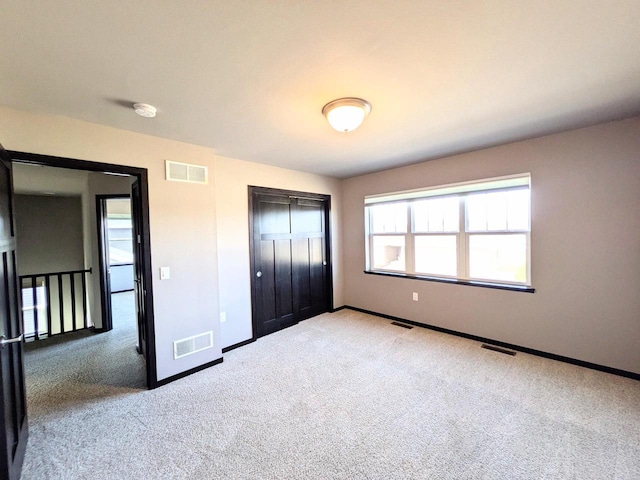 unfurnished bedroom featuring visible vents and a closet