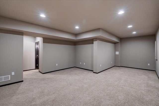 finished below grade area featuring recessed lighting, visible vents, and baseboards