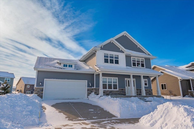 craftsman inspired home featuring a porch, stone siding, driveway, and a garage