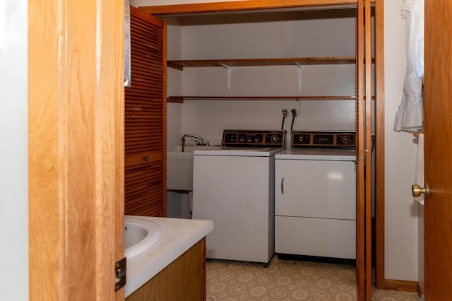 clothes washing area with washing machine and clothes dryer