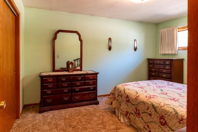 bedroom featuring baseboards, a closet, and light carpet