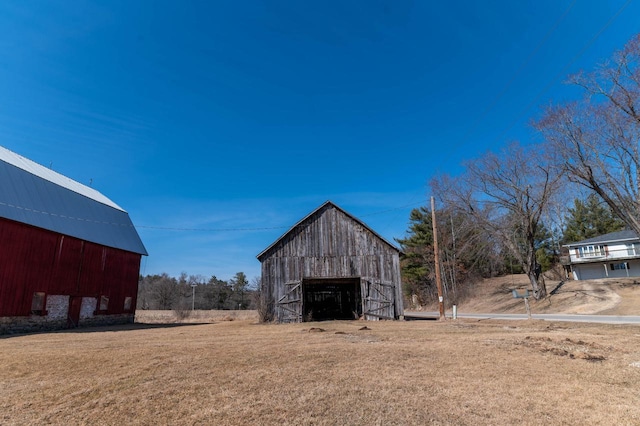 view of barn with a lawn