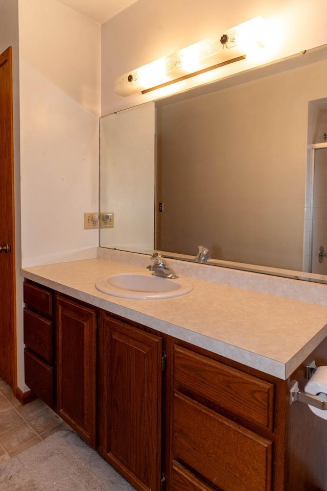 bathroom with a shower and vanity