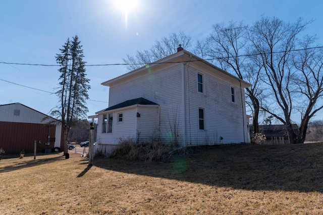 exterior space with a lawn and a chimney