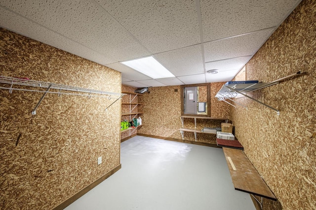 interior space featuring electric panel and a drop ceiling