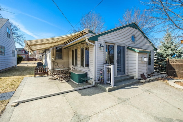 rear view of property with a patio area and fence