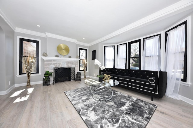 living area with baseboards, a wealth of natural light, and ornamental molding