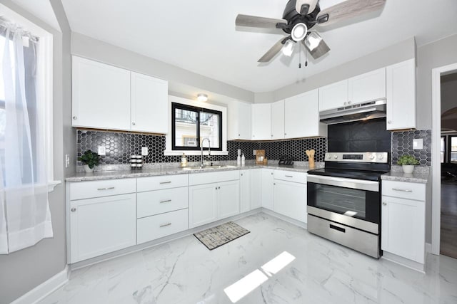 kitchen featuring marble finish floor, electric stove, under cabinet range hood, a sink, and white cabinetry