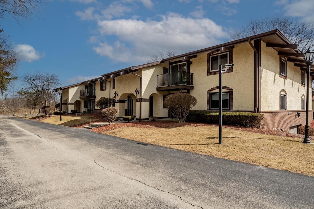 N82W13510 Fond Du Lac Ave Unit B103, Menomonee Falls, WI 53051 - view of front of home with stucco siding and a balcony