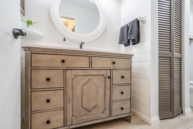 bathroom featuring a closet, toilet, and vanity