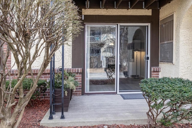 doorway to property with stucco siding