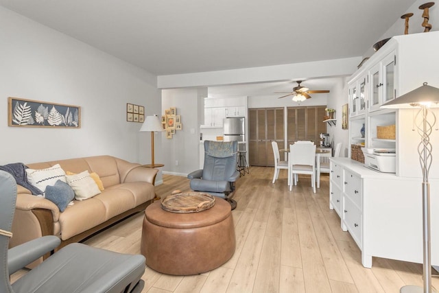 living room featuring a ceiling fan and light wood-style floors