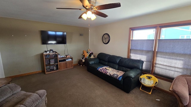 living area with carpet flooring, baseboards, and a ceiling fan