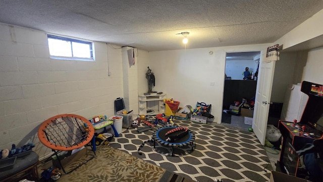 game room with a textured ceiling