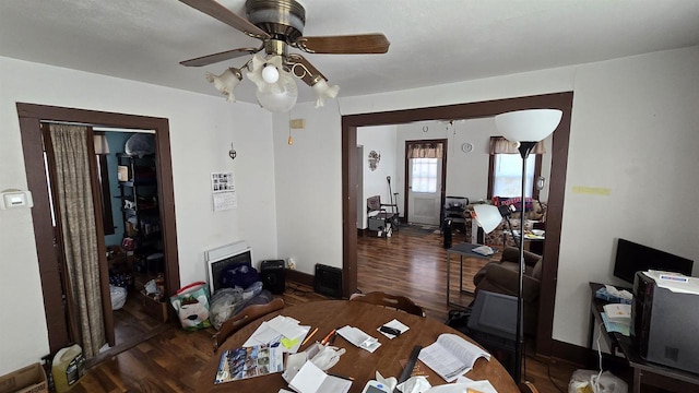 dining area with wood finished floors, baseboards, and ceiling fan