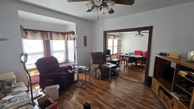 living room with wood finished floors and ceiling fan