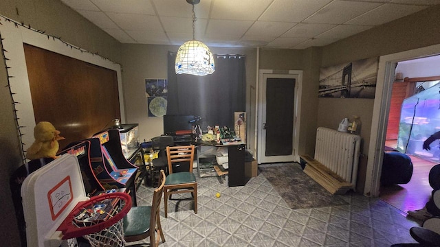 dining room with tile patterned floors, a paneled ceiling, and radiator heating unit