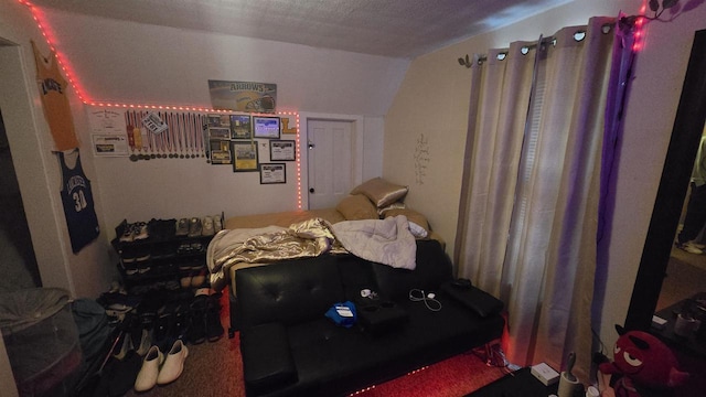 bedroom with a textured ceiling and vaulted ceiling