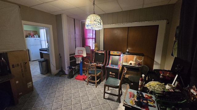 rec room featuring tile patterned floors and a paneled ceiling