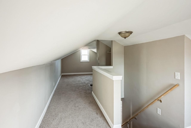 additional living space featuring lofted ceiling, baseboards, and carpet floors