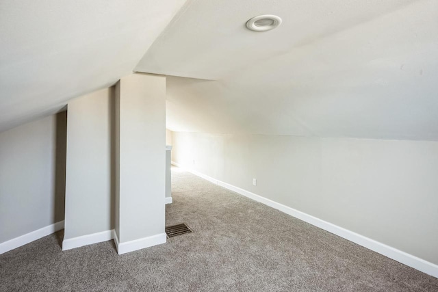 additional living space featuring carpet flooring, visible vents, and baseboards