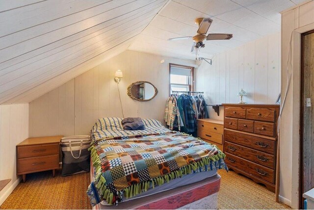 bedroom featuring vaulted ceiling, light colored carpet, and ceiling fan