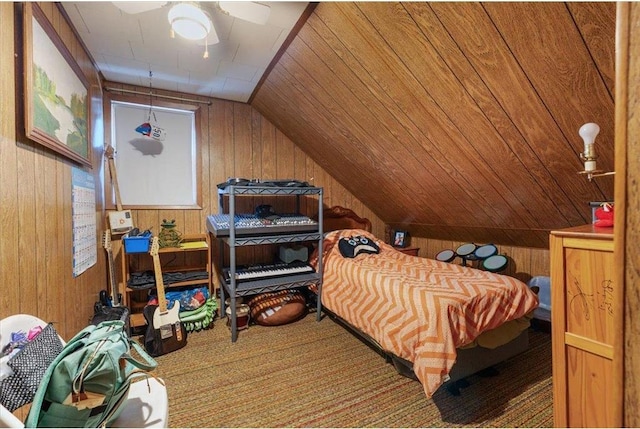 bedroom featuring vaulted ceiling, carpet, wood walls, and wooden ceiling