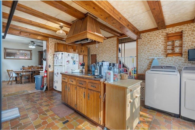 kitchen with freestanding refrigerator, ceiling fan, stone finish floor, beamed ceiling, and washer and clothes dryer