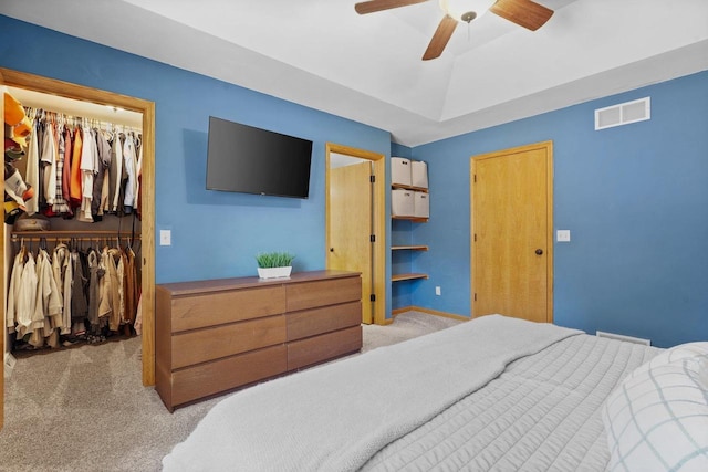 bedroom with a ceiling fan, carpet, visible vents, a spacious closet, and a closet