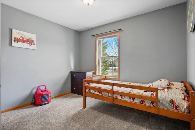 bedroom featuring baseboards and carpet floors