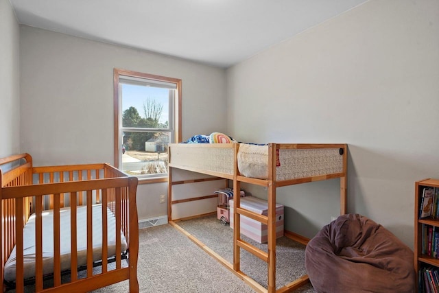 bedroom featuring baseboards and carpet