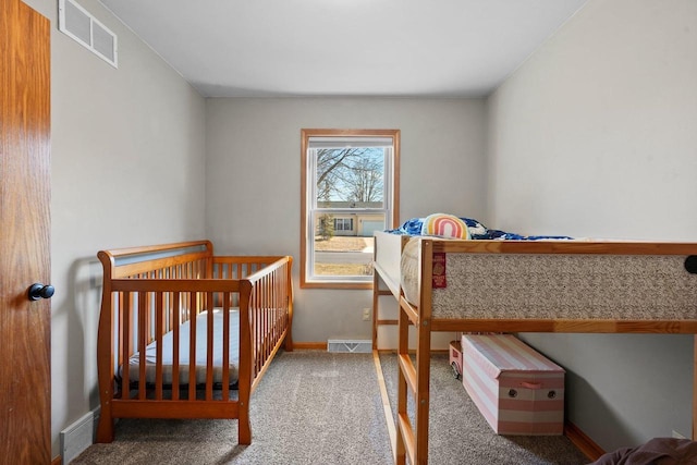 carpeted bedroom with visible vents and baseboards