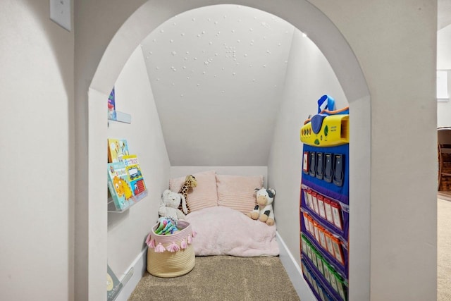 game room featuring vaulted ceiling, carpet flooring, and arched walkways