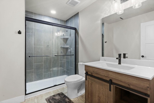 full bath with visible vents, vanity, toilet, and a shower stall