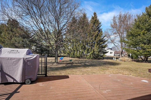 wooden deck with grilling area and a yard