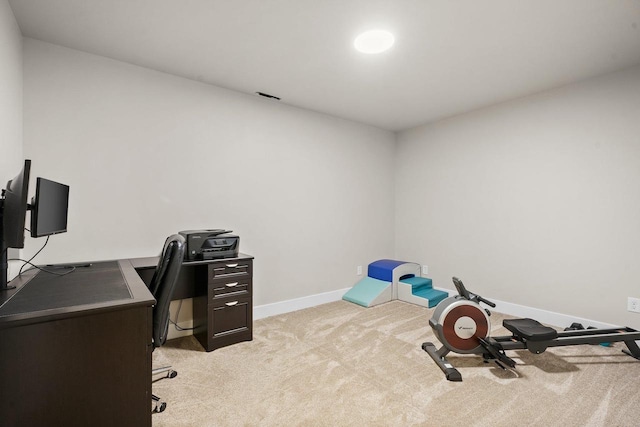 office area with visible vents, baseboards, and light colored carpet