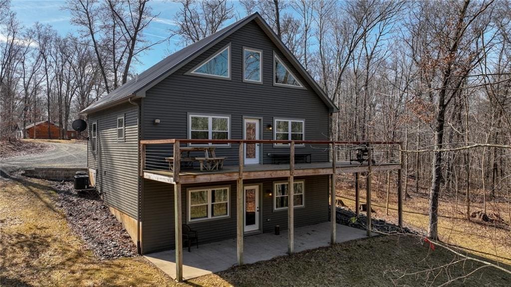 back of house featuring a patio and a wooden deck