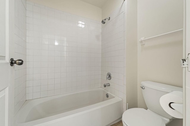 bathroom featuring tub / shower combination and toilet