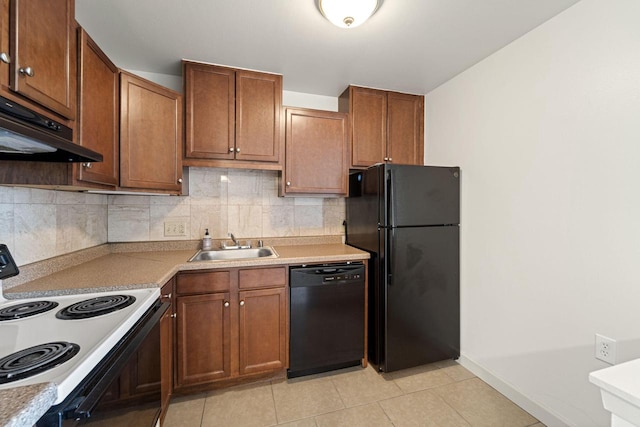 kitchen with black appliances, under cabinet range hood, a sink, tasteful backsplash, and light tile patterned floors