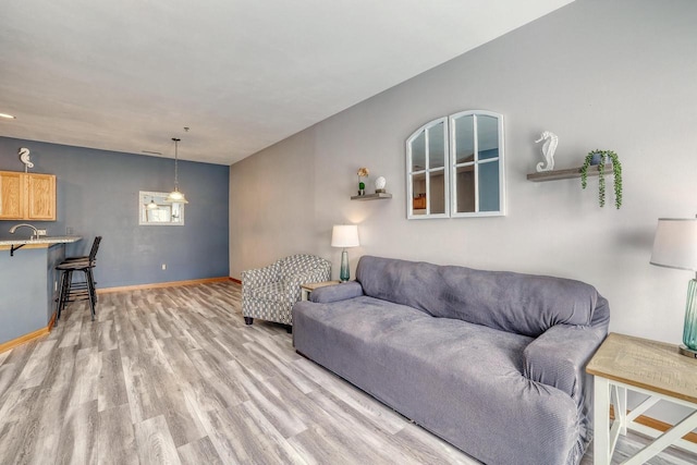 living room with light wood-style flooring and baseboards