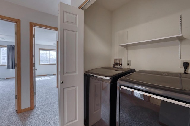 laundry room with visible vents, washing machine and dryer, carpet, baseboards, and laundry area