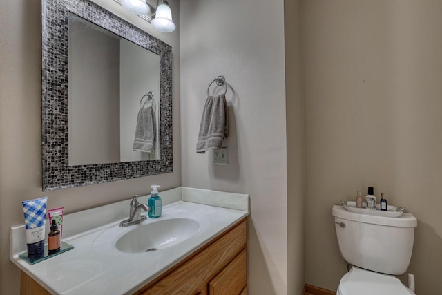 bathroom with toilet and vanity