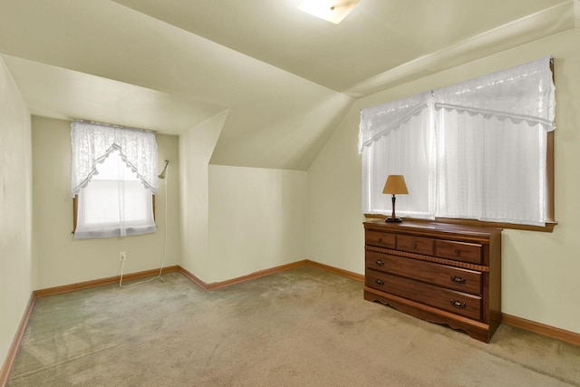 additional living space featuring lofted ceiling, baseboards, and carpet floors