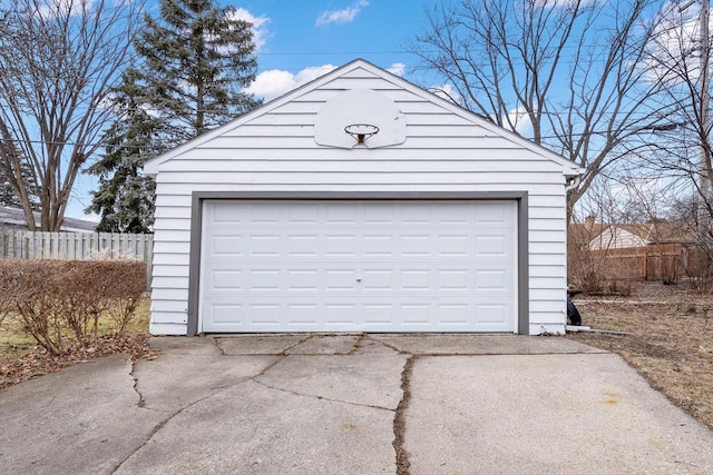 detached garage featuring fence