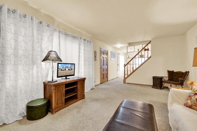 living area with stairway and carpet floors