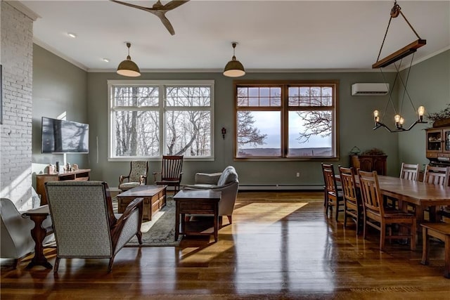 living area featuring wood finished floors, ornamental molding, an AC wall unit, ceiling fan with notable chandelier, and baseboard heating