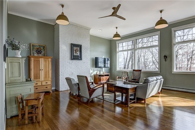 living room with ceiling fan, a baseboard heating unit, wood finished floors, and crown molding